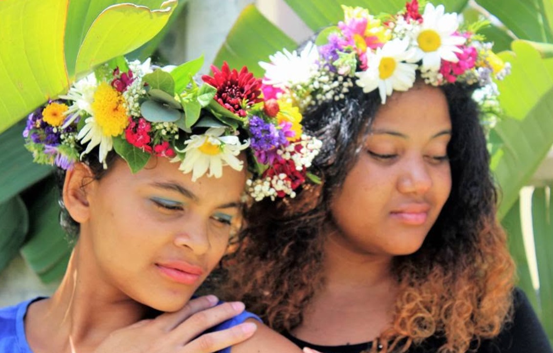 Two colourful fresh flower crowns worn for a celebration